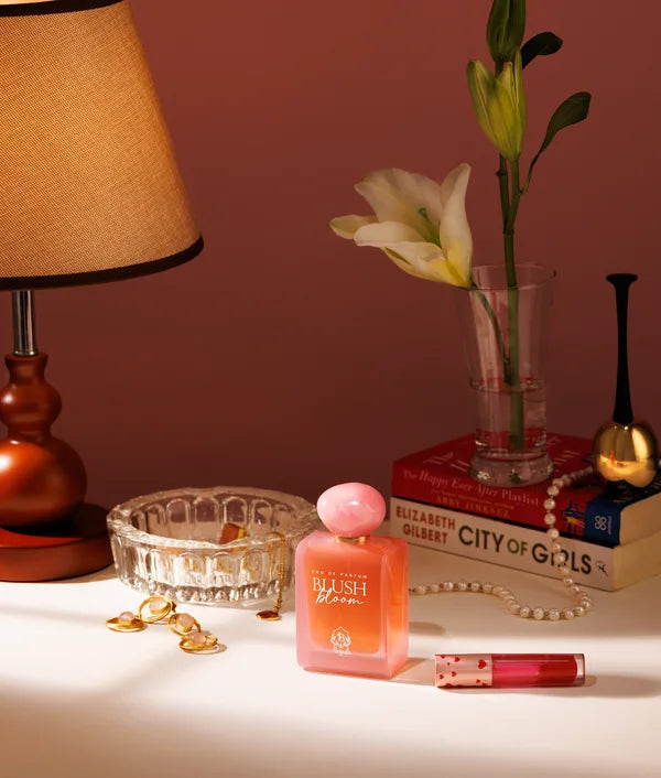 Blush Bloom on a bedside table beside a lily and a lamp