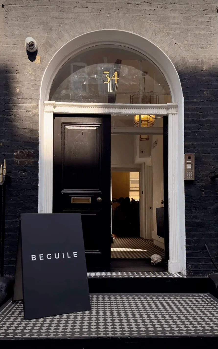 A Beguile sign outside a London townhouse for the Sip & Paint evening